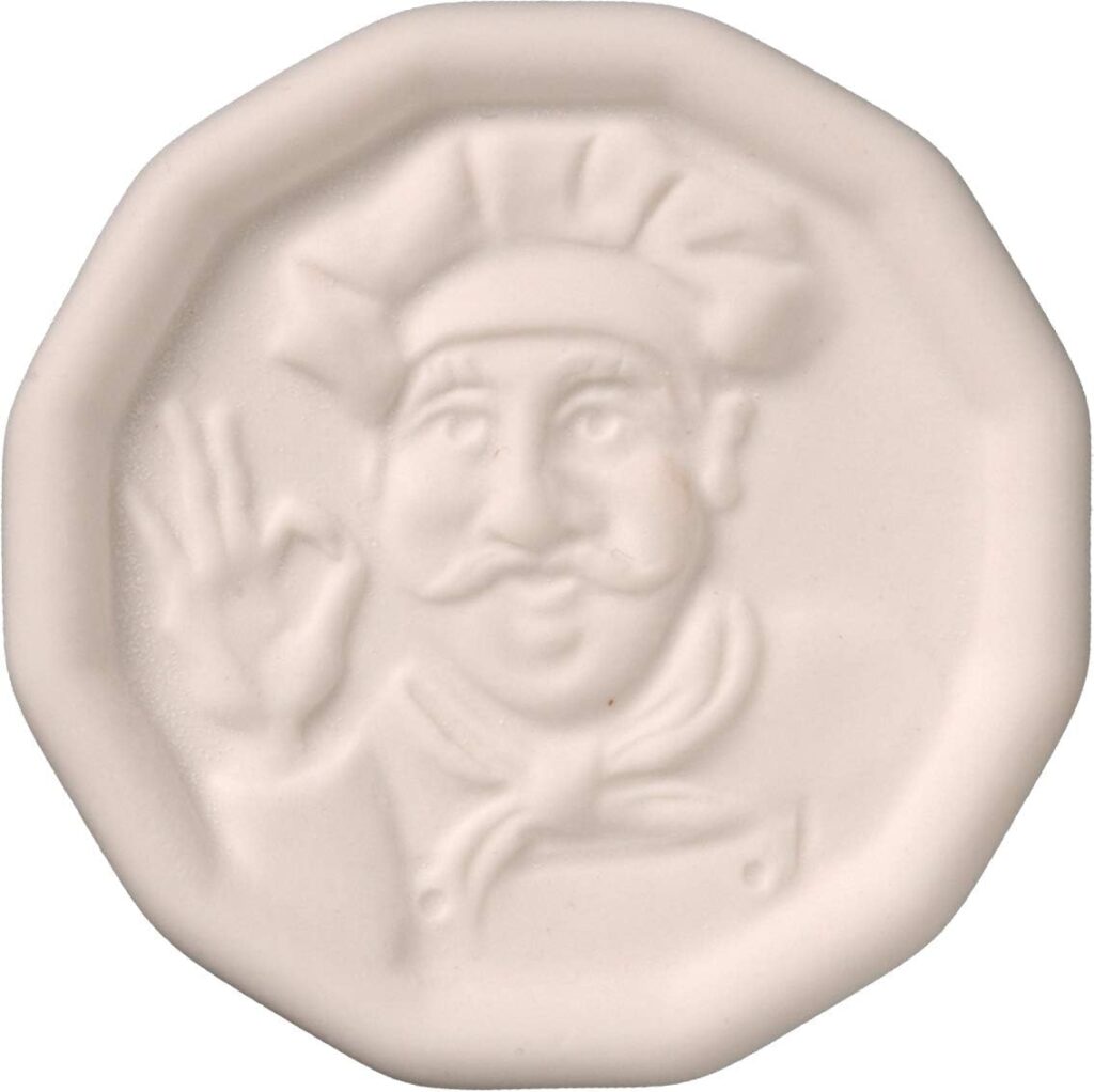 A ceramic cream coloured coin shaped pot watcher. The coin rattles when in boiling water.